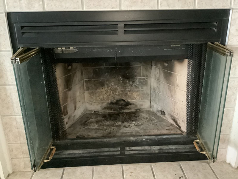 Close up of fire box example photo for virtual assessment with glass doors and black surround.