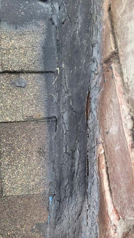 Stock photo - damaged flashing - Hudson Chimney Damaged flashing where the chimney meets the roof.