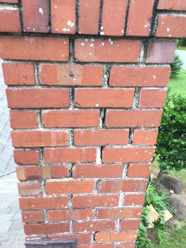 Before Masonry Tuck Point Repair. Cracks in mortar of red brick chimney