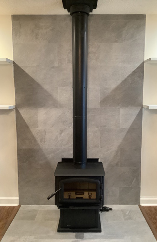 We sell many stove and insert products.  Pictured is a wood stove installed with a round black flue.
